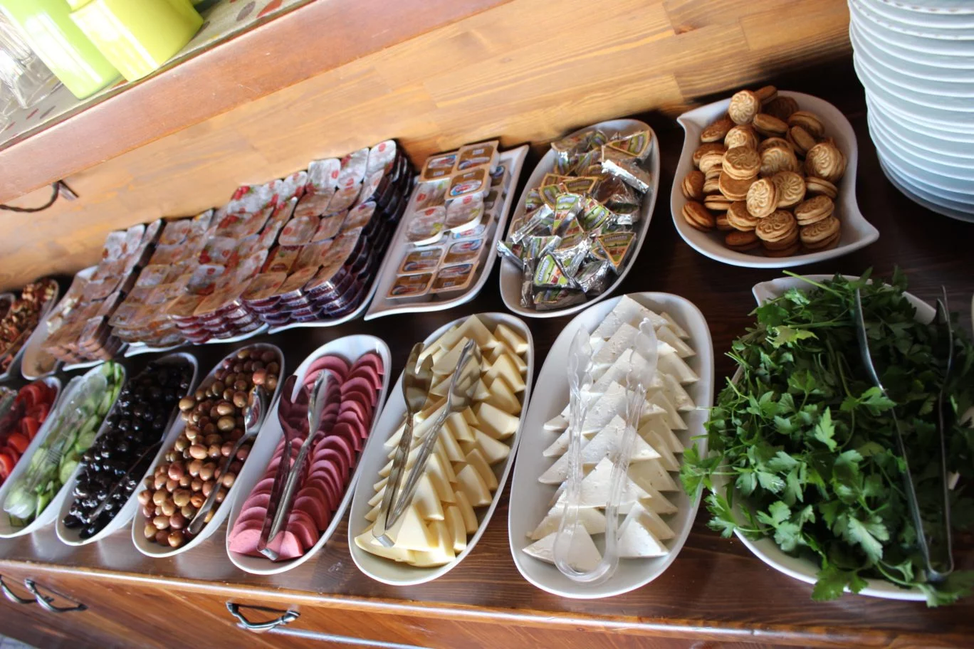 turkish breakfast with bread, eggs, cheese, vegetables, olives, cold-cuts, milk, pomegranate juice,