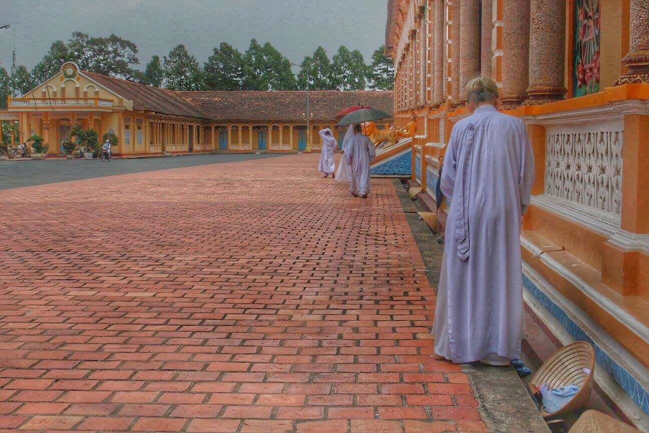 cai dai temple worshipper old lady vietnamese in white robe