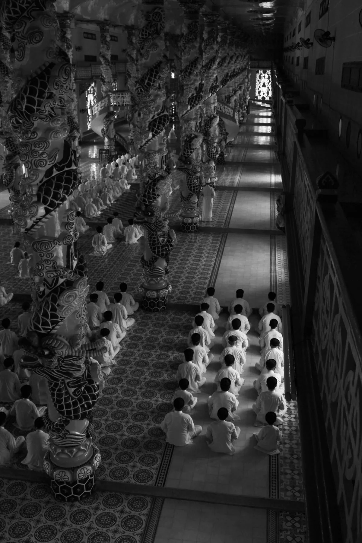 cao dai temple vietnam worshippers religion people black and white