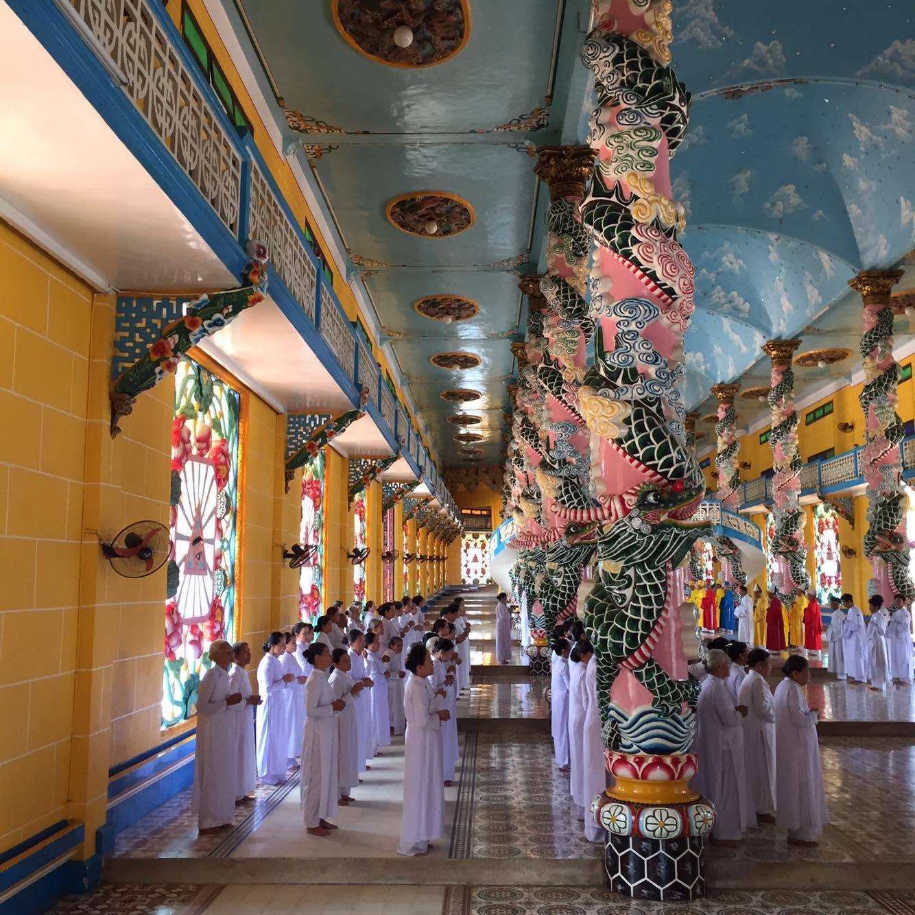 cao dai temple worshippers standing altar 12 noon vietnam
